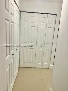 hallway featuring light tile patterned floors