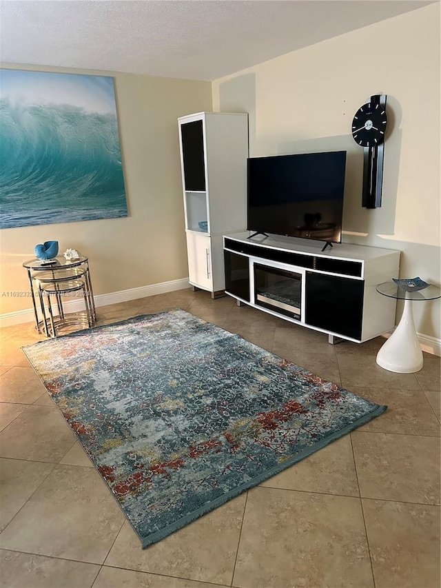 tiled living room featuring a textured ceiling