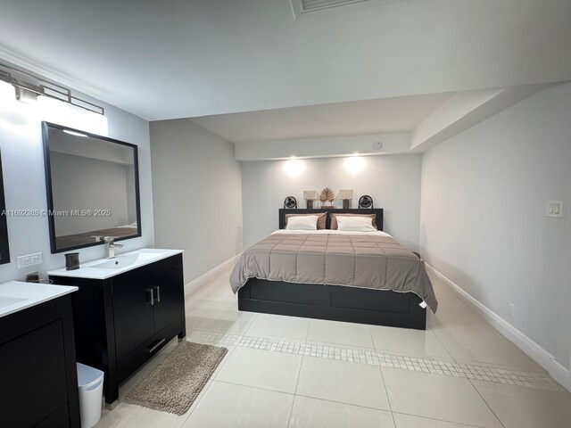 kitchen with stainless steel refrigerator, dark brown cabinetry, a breakfast bar area, and light tile patterned floors