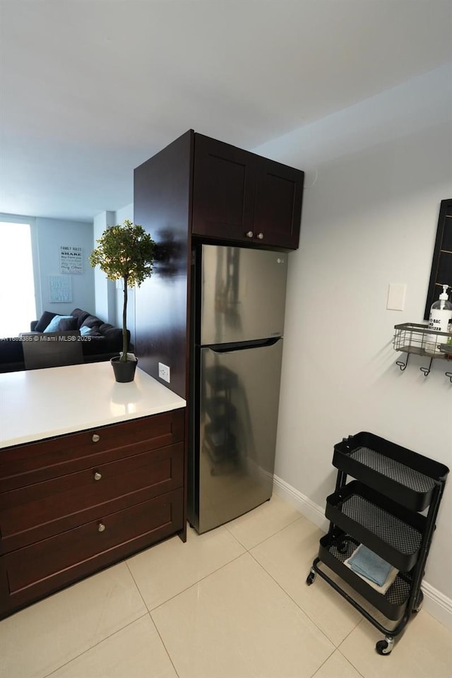 209 N Fort Lauderdale Beach Blvd Unit 7D, Fort Lauderdale, FL 33304 - kitchen featuring freestanding refrigerator, light countertops, light tile patterned floors, baseboards, and open floor plan