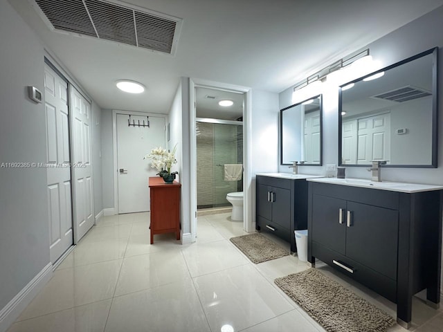 bathroom with vanity, tile patterned flooring, a shower with shower door, and toilet