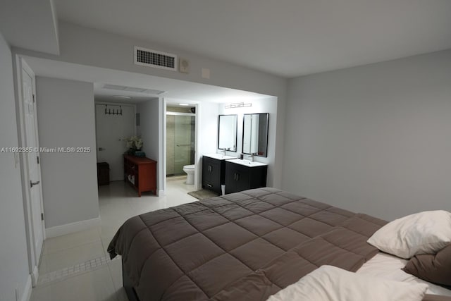 209 N Fort Lauderdale Beach Blvd Unit 7D, Fort Lauderdale, FL 33304 - bedroom with light tile patterned floors, a sink, ensuite bathroom, and baseboards