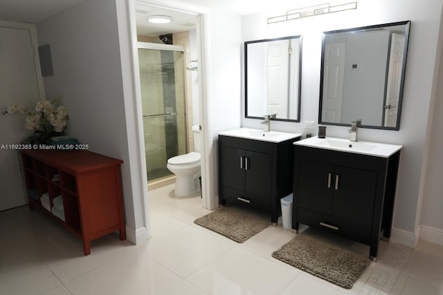 209 N Fort Lauderdale Beach Blvd Unit 7D, Fort Lauderdale, FL 33304 - full bathroom featuring a stall shower, two vanities, toilet, tile patterned floors, and baseboards