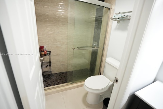 209 N Fort Lauderdale Beach Blvd Unit 7D, Fort Lauderdale, FL 33304 - full bathroom featuring a shower stall, toilet, and tile patterned floors