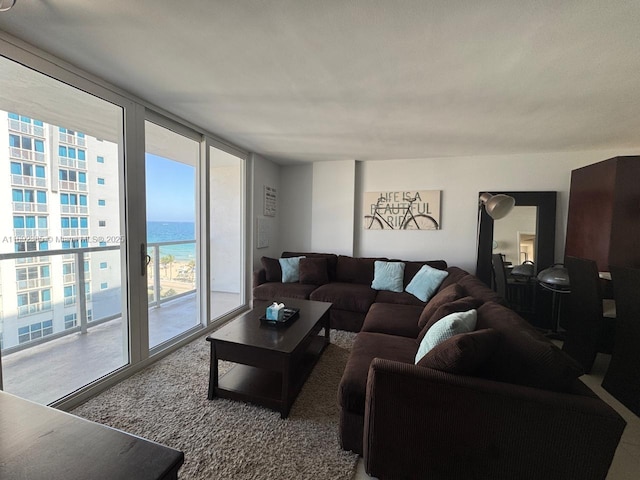 living room featuring expansive windows and a water view