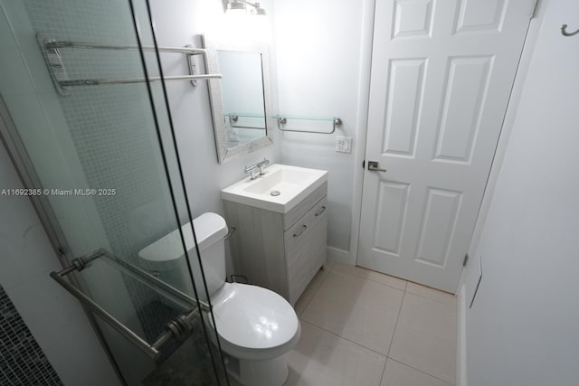 209 N Fort Lauderdale Beach Blvd Unit 7D, Fort Lauderdale, FL 33304 - bathroom featuring toilet, a stall shower, tile patterned floors, and vanity