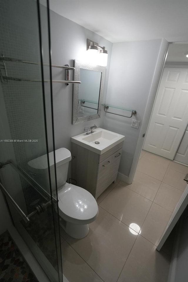 209 N Fort Lauderdale Beach Blvd Unit 7D, Fort Lauderdale, FL 33304 - full bathroom with tile patterned flooring, a shower with door, vanity, and toilet