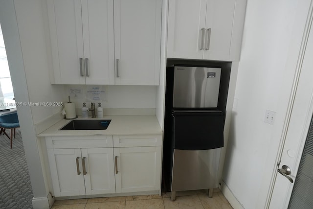 209 N Fort Lauderdale Beach Blvd Unit 7D, Fort Lauderdale, FL 33304 - kitchen with freestanding refrigerator, light countertops, white cabinets, and baseboards