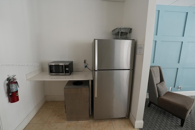 209 N Fort Lauderdale Beach Blvd Unit 7D, Fort Lauderdale, FL 33304 - kitchen featuring stainless steel appliances, baseboards, and light countertops
