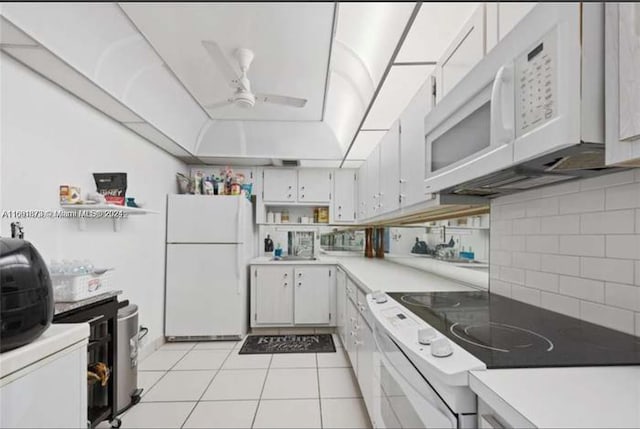 kitchen with decorative backsplash, light tile patterned floors, ceiling fan, white cabinetry, and white appliances