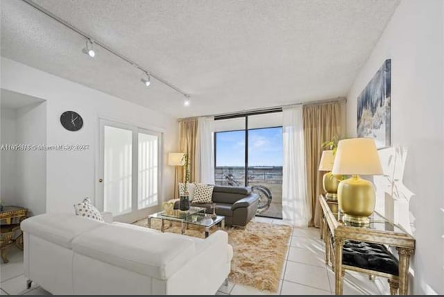 tiled living room with a textured ceiling and rail lighting