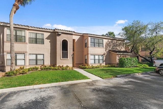 mediterranean / spanish-style home featuring a front lawn