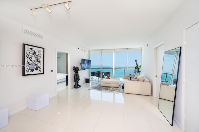 465 E Brickell Ave Unit 5305, Miami, FL 33131 - tiled living room featuring healthy amount of natural light, floor to ceiling windows, and baseboards