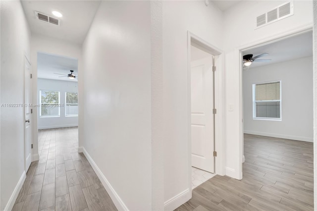 hallway with light hardwood / wood-style flooring