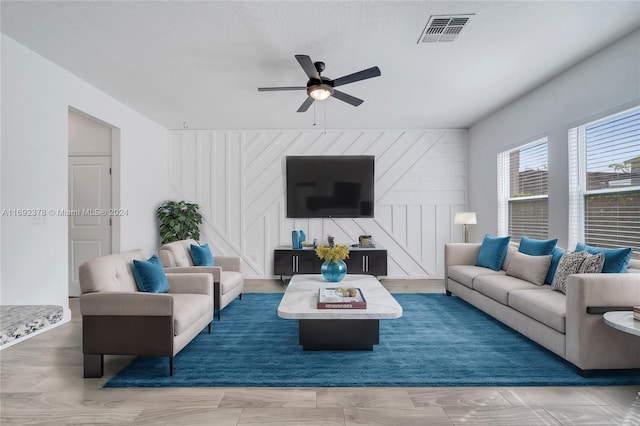 living room with ceiling fan, wooden walls, and dark hardwood / wood-style flooring