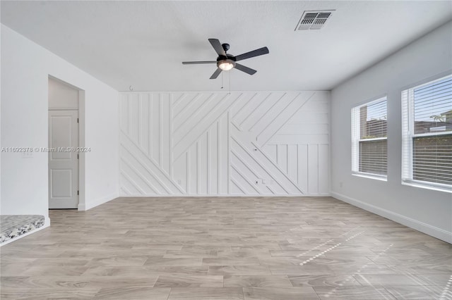 unfurnished living room featuring light wood-type flooring and ceiling fan