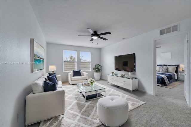 living room featuring light carpet and ceiling fan