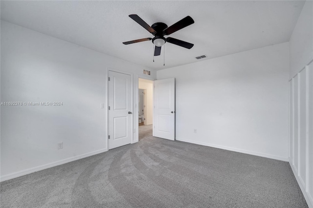 empty room with carpet and ceiling fan