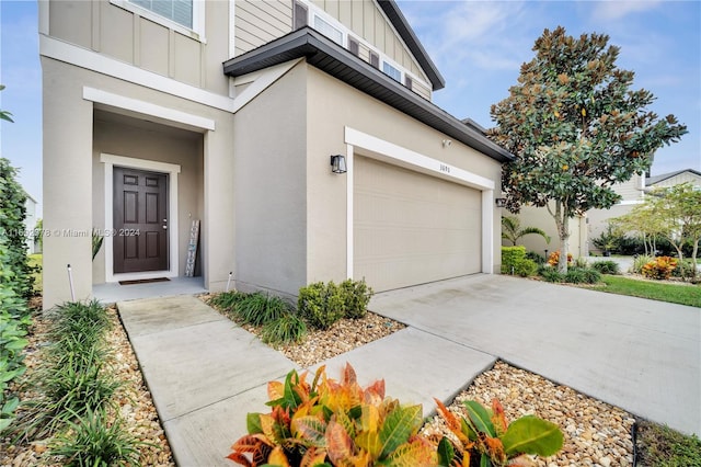 view of exterior entry with a garage