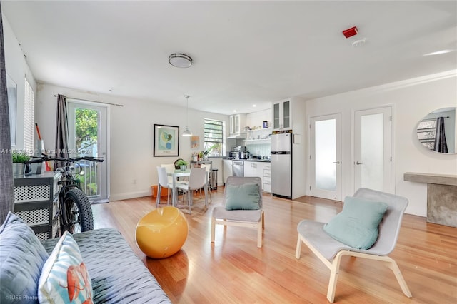 living room featuring plenty of natural light and light hardwood / wood-style flooring