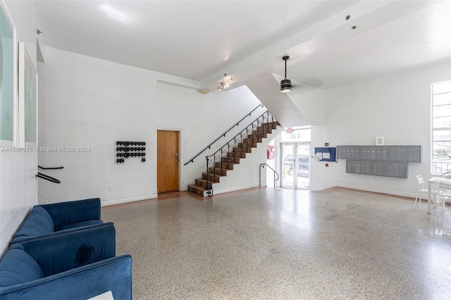 living room with a wealth of natural light, ceiling fan, and mail boxes