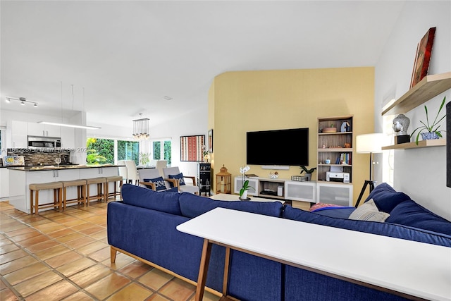 living room featuring light tile patterned floors and lofted ceiling