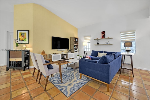 living room with tile patterned flooring, a healthy amount of sunlight, and high vaulted ceiling