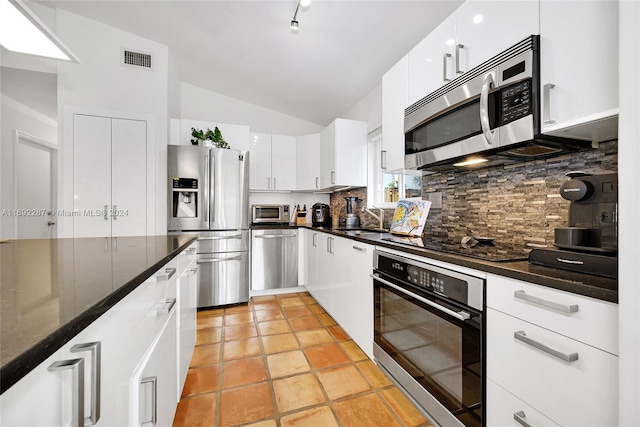 kitchen featuring sink, white cabinets, stainless steel appliances, and lofted ceiling