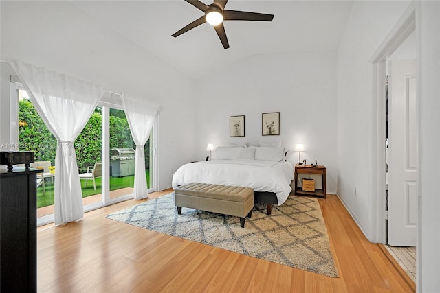 bedroom featuring access to outside, light hardwood / wood-style floors, vaulted ceiling, and ceiling fan