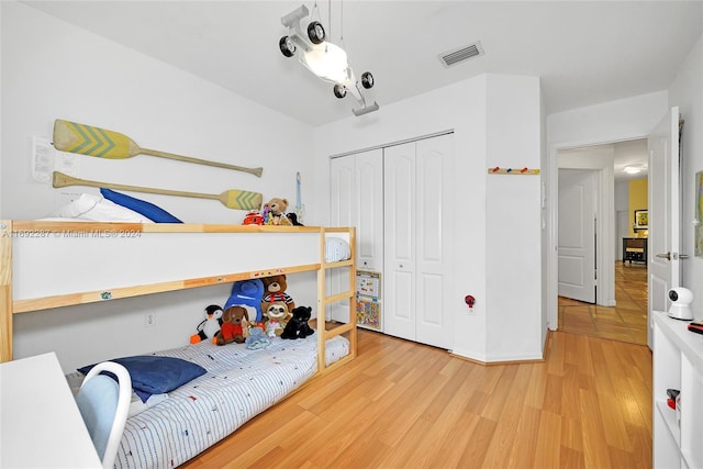 bedroom with a closet and hardwood / wood-style floors