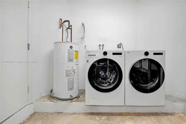 laundry room featuring washing machine and dryer and electric water heater