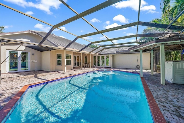 view of swimming pool with french doors, a patio area, and a lanai