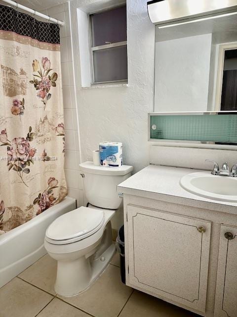 full bathroom with vanity, shower / bath combo with shower curtain, tile patterned flooring, and toilet