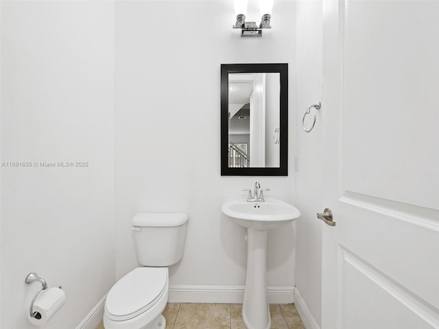 bathroom featuring sink, tile patterned floors, and toilet