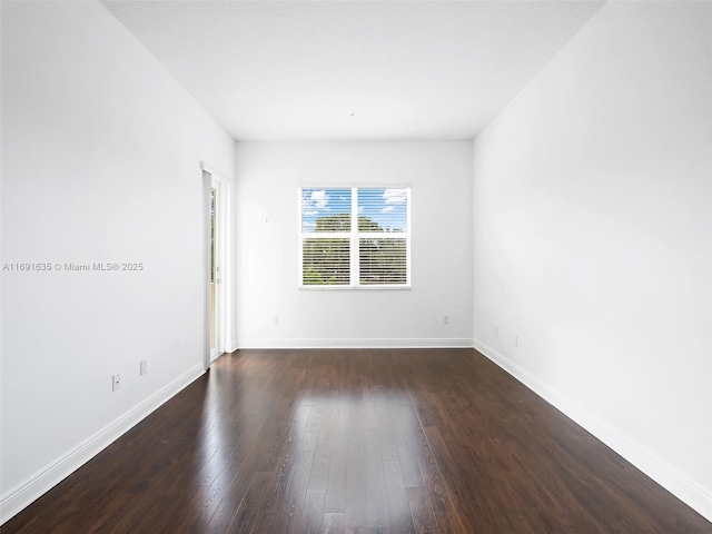 spare room featuring dark hardwood / wood-style flooring