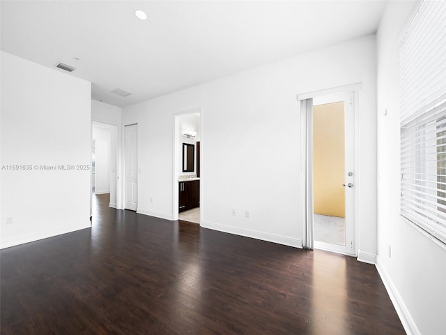 unfurnished room featuring dark hardwood / wood-style flooring