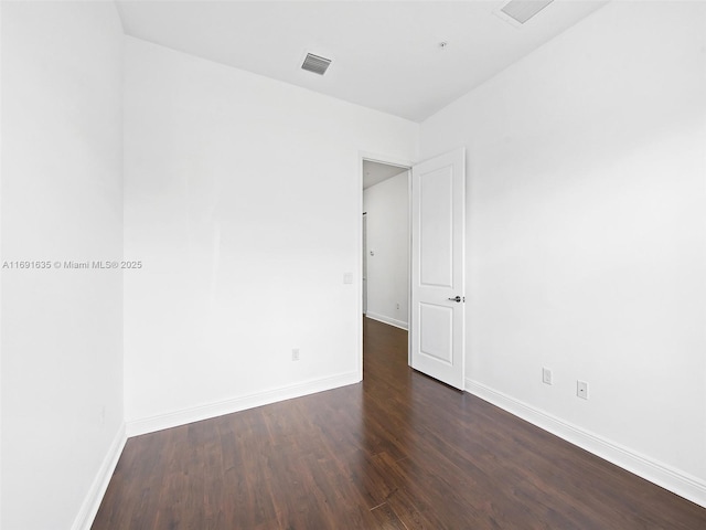 spare room featuring dark hardwood / wood-style floors