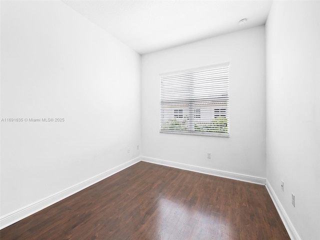 unfurnished room featuring dark hardwood / wood-style flooring