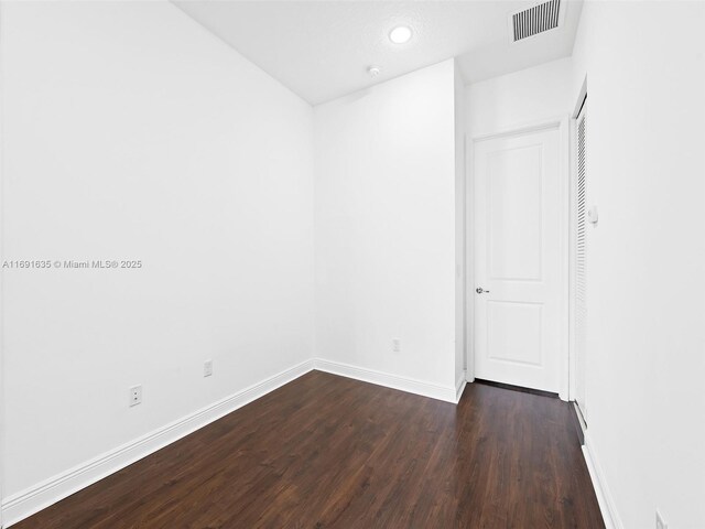 empty room featuring dark hardwood / wood-style flooring