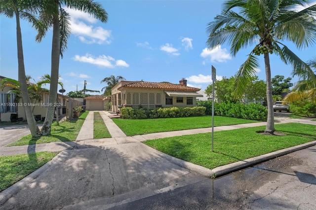 mediterranean / spanish-style house with a garage and a front lawn