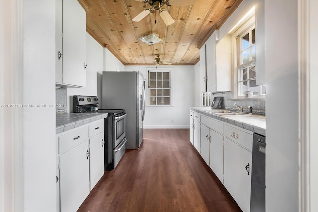 kitchen with white cabinets, tile countertops, wooden ceiling, and appliances with stainless steel finishes