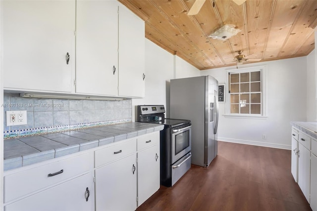 kitchen with tile countertops, white cabinetry, appliances with stainless steel finishes, and dark hardwood / wood-style floors