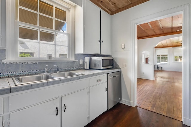 kitchen featuring wooden ceiling, tile countertops, white cabinetry, and stainless steel appliances