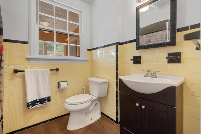 bathroom with vanity, tile walls, and wood-type flooring