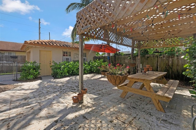 view of patio featuring an outdoor structure and a pergola