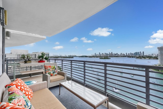 balcony with a view of city and an outdoor hangout area