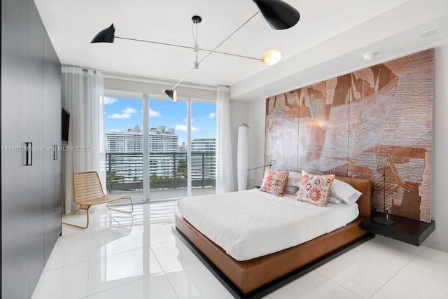 bedroom featuring light tile patterned floors and access to outside