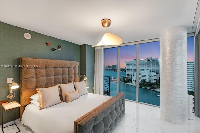 tiled bedroom featuring a city view, access to outside, a wall of windows, and wallpapered walls