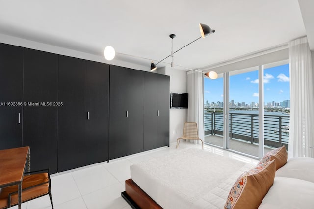 bedroom with access to exterior and light tile patterned floors