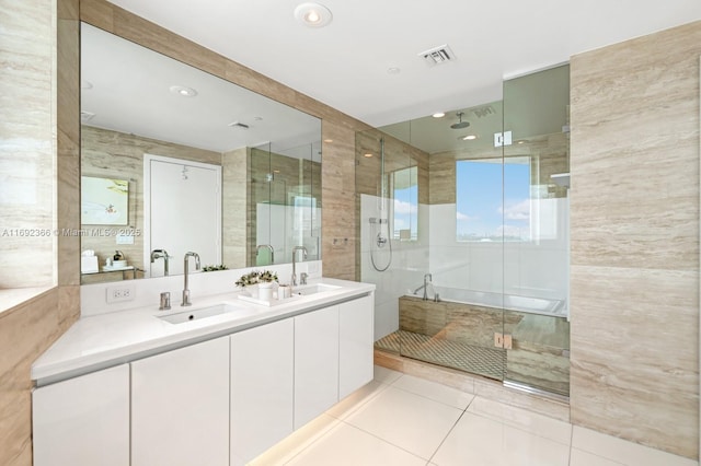 full bath with visible vents, a sink, and a shower stall